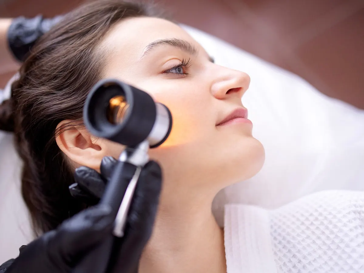 Woman having her face examined for skin cancer in Jacksonville, FL