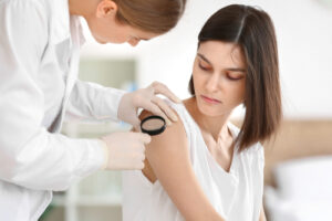 Woman having a mole examined for melanoma in Jacksonville, FL